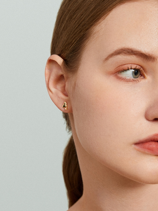Close-up of ear showing smooth earlobe after repair for split, stretched holes, and improved symmetry