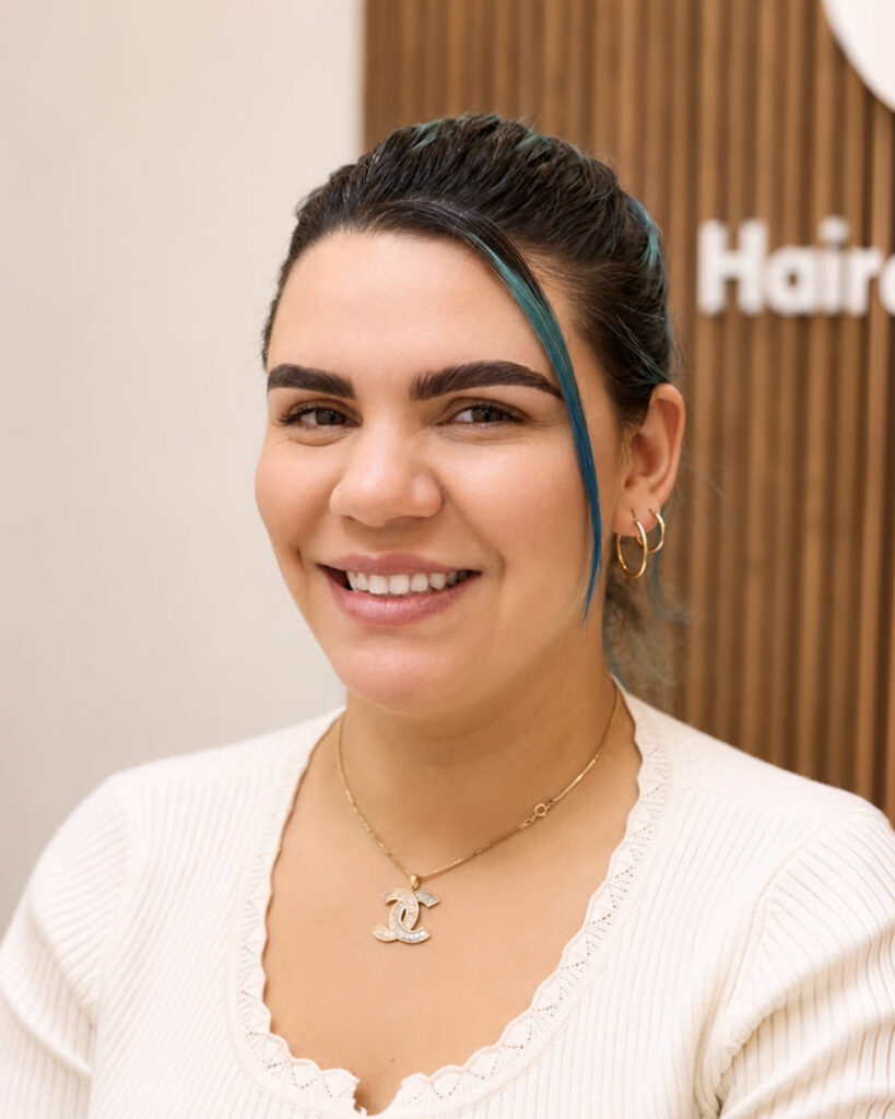 Alt text: Woman with natural-looking eyebrows illustrating how precise graft placement and direction support balanced transplant results.